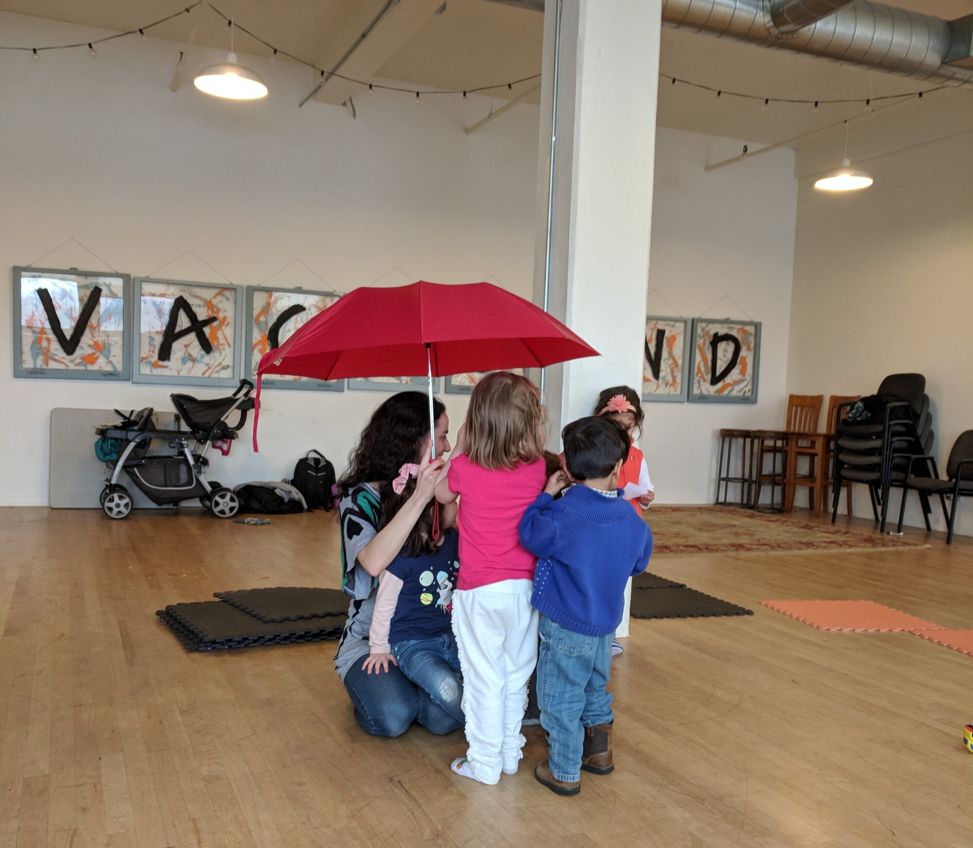 children standing under an umbrella