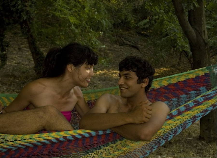 Two actors in a hammock together.