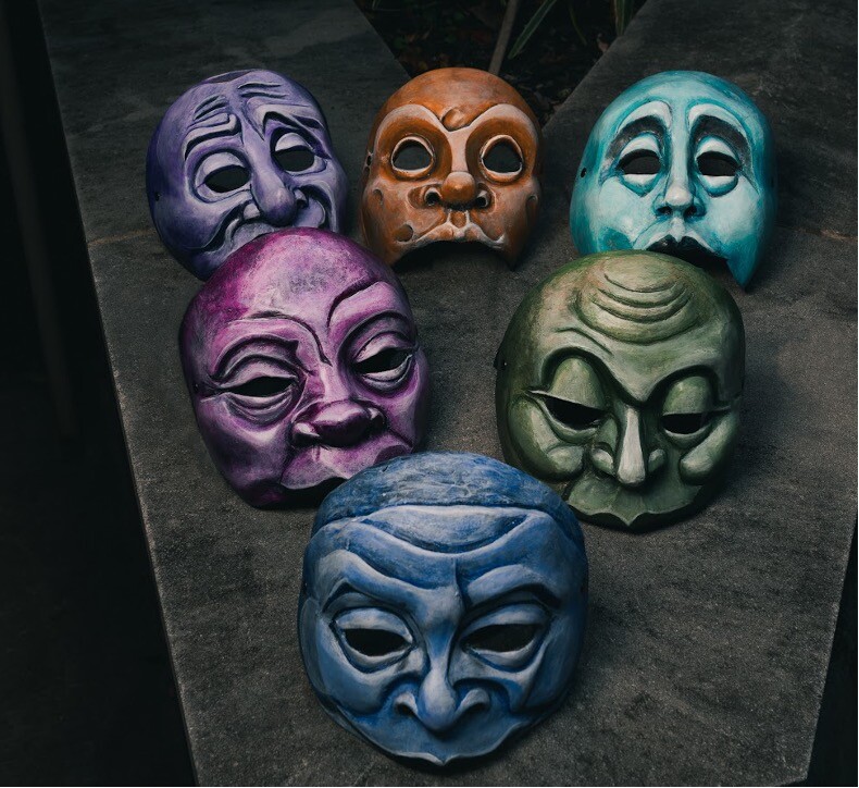 A collection of brightly colored commedia dell'arte masks.