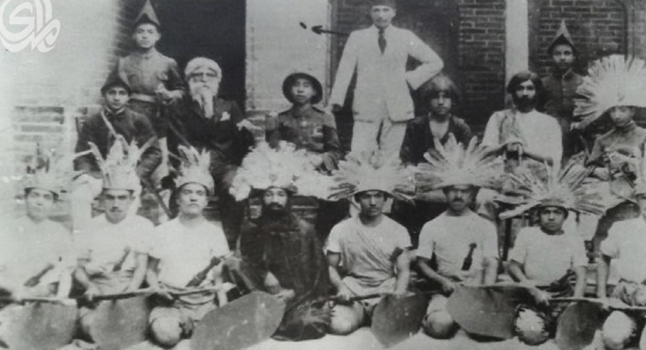 Members of an Iraqi political theatre group pose outside in costume.