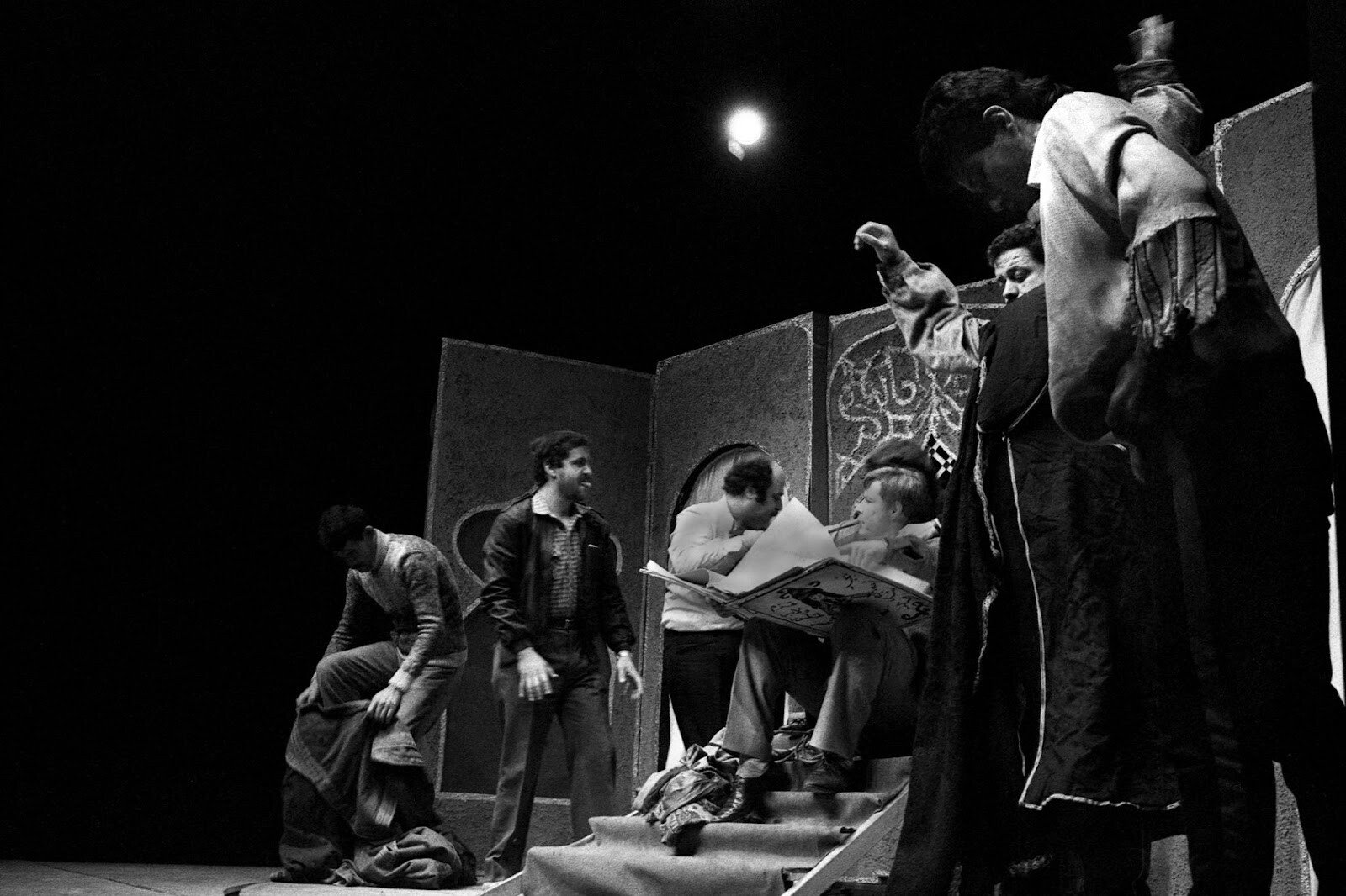 A  black and white photo of a  group of artists performing on stage.