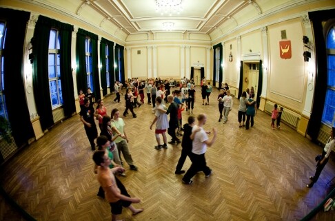 Dancers move around a ballroom during a rehearsal.